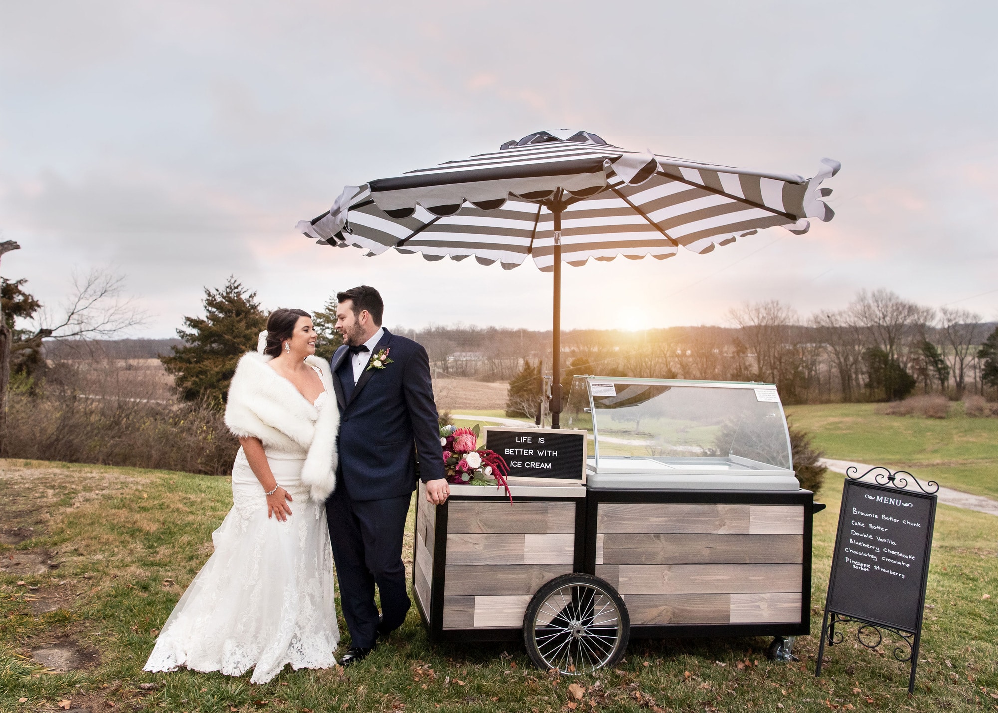 Bride and Groom posing next to ice cream cart